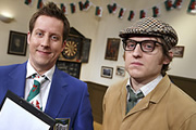 The Committee Meeting. Image shows from L to R: Mr Chairman (Chris Corcoran), Rex (Elis James). Copyright: BBC