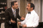 Fawlty Towers. Image shows from L to R: Basil Fawlty (John Cleese), Manuel (Andrew Sachs). Copyright: BBC