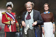 Professor Branestawm. Image shows from L to R: Colonel Dedshott (Simon Day), Professor Branestawm (Harry Hill), Mrs. Flittersnoop (Vicki Pepperdine). Copyright: BBC