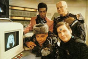 Red Dwarf. Image shows from L to R: Lister (Craig Charles), Cat (Danny John-Jules), Rimmer (Chris Barrie), Kryten (Robert Llewellyn). Copyright: Grant Naylor Productions / BBC