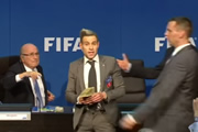 Lee Nelson showers Sepp Blatter with banknotes. Simon Brodkin