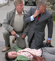 Doc Martin. Image shows from L to R: Clive Tishell (Malcolm Storry), Barbara (Georgie Glen), Dr Martin Ellingham (Martin Clunes). Copyright: Buffalo Pictures / Homerun Productions