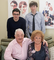 Friday Night Dinner. Image shows from L to R: Adam (Simon Bird), Mr Morris (Harry Landis), Jonny (Tom Rosenthal), Nellie (Frances Cuka). Copyright: Popper Pictures / Big Talk Productions