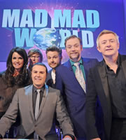 Mad Mad World. Image shows from L to R: Janice Dickinson, Rhys Darby, Paddy McGuinness, Rob Rouse, Rufus Hound, Louis Walsh. Copyright: Roughcut Television
