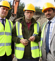 Twenty Twelve. Image shows from L to R: Ian Fletcher (Hugh Bonneville), Richard Watson (Simon Scardifield), Martin Soper (Nitin Ganatra). Copyright: BBC