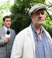 Twenty Twelve. Image shows from L to R: Reporter (John Hollingworth), Tony Ward (Tim McInnerny). Copyright: BBC