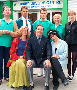 The Brittas Empire. Image shows from L to R: Colin Wetherby (Mike Burns), Helen Brittas (Pippa Haywood), Gavin Featherly (Tim Marriott), Gordon Brittas (Chris Barrie), Tim Whistler (Russell Porter), Carole Parkinson (Harriet Thorpe), Linda (Jill Greenacre), Julie (Judy Flynn). Copyright: BBC