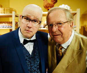 Bull. Image shows from L to R: Mr Richards (Matt Lucas), Egg Shop Owner (Tim Brooke-Taylor). Copyright: John Stanley Productions