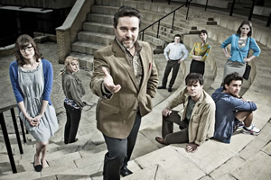 Campus. Image shows from L to R: Imogen Moffat (Lisa Jackson), Nicole Huggins (Sara Pascoe), Jonty de Wolfe (Andy Nyman), Jason Armitage (Will Adamsdale), Matt Beer (Joseph Millson), Lydia Tennant (Dolly Wells), Flatpack (Jonathan Bailey), Georgina 'George' Bryan (Katherine Ryan). Copyright: Monicker Pictures