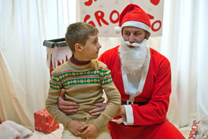 Little Crackers. Image shows from L to R: Young Chris (Robert Donnelly), Santa (Chris O'Dowd)