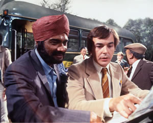 Mind Your Language. Image shows from L to R: Ranjeet Singh (Albert Moses), Jeremy Brown (Barry Evans). Copyright: London Weekend Television