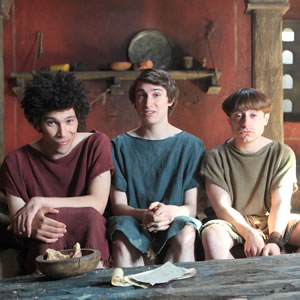 Plebs. Image shows from L to R: Stylax (Joel Fry), Marcus (Tom Rosenthal), Grumio (Ryan Sampson). Copyright: RISE Films