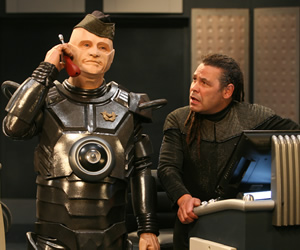 Red Dwarf. Image shows from L to R: Kryten (Robert Llewellyn), Lister (Craig Charles). Copyright: Grant Naylor Productions / BBC