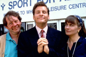 The Brittas Empire. Image shows from L to R: Colin Wetherby (Mike Burns), Gordon Brittas (Chris Barrie), Laura Lancing (Julia St. John). Copyright: BBC