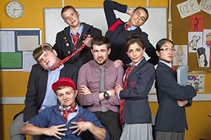 Bad Education. Image shows left to right: Joe (Ethan Lawrence), Rem Dogg (Jack Binstead), Mitchell (Charlie Wernham), Alfie (Jack Whitehall), Stephen Carmichael (Layton Williams), Chantelle (Nikki Runeckles), Jing (Kae Alexander). Credit: Tiger Aspect Productions