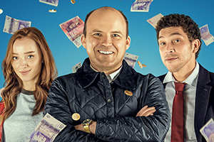 The Bank Of Dave. Image shows left to right: Alexandra (Phoebe Dynevor), Dave Fishwick (Rory Kinnear), Hugh (Joel Fry)