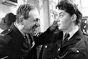 Carry On, Constable. Image shows from L to R: Sgt. Frank Wilkins (Sid James), Desk Sgt. Laura Moon (Hattie Jacques). Copyright: Peter Rogers Productions