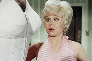 Carry On Girls. Image shows left to right: Peter Potter (Bernard Bresslaw), Hope Springs (Barbara Windsor). Credit: Rank Organisation, ITV