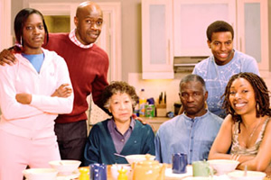 The Crouches. Image shows from L to R: Adele Crouch (Ony Uhiara), Roly Crouch (Robbie Gee), Grandma Sylvie Crouch (Mona Hammond), Grandpa Langley Crouch (Rudolph Walker), Aiden Crouch (Akemnji Ndifornyen), Natalie Crouch (Jo Martin). Copyright: BBC