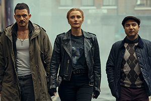 Deep Cover. Image shows left to right: Marlon (Orlando Bloom), Kat (Bryce Dallas Howard), Hugh (Nick Mohammed)