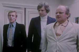 Eskimo Nell. Image shows from L to R: Harris Tweedle (Christopher Timothy), Denis Morrison (Michael Armstrong), Benny U. Murdoch (Roy Kinnear). Copyright: Salon Productions