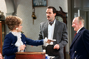 Fawlty Towers. Image shows from L to R: Sybil Fawlty (Prunella Scales), Basil Fawlty (John Cleese), Major Gowen (Ballard Berkeley). Copyright: BBC