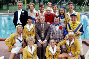 Hi-De-Hi!. Image shows from L to R: Mary (Penny Irving), Barry Stuart-Hargreaves (Barry Howard), Gladys Pugh (Ruth Madoc), Yvonne Stuart-Hargreaves (Diane Holland), Stanley Matthews (David Webb), Jeffrey Fairbrother (Simon Cadell), Mr Partridge (Leslie Dwyer), Gary Bolton (Chris Andrews), Bruce Matthews (Tony Webb), Ted Bovis (Paul Shane), Peggy Ollerenshaw (Su Pollard), Spike Dixon (Jeffrey Holland), Betty Whistler (Rikki Howard), Fred Quilly (Felix Bowness). Copyright: BBC