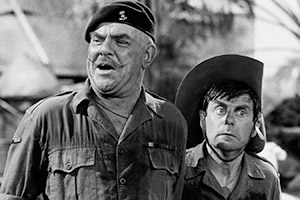 It Ain't Half Hot Mum. Image shows from L to R: BSM Geoffrey 'Shut Up' Williams (Windsor Davies), Bombardier 'Gloria' Beaumont (Melvyn Hayes). Copyright: BBC