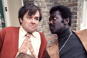 Love Thy Neighbour. Image shows from L to R: Eddie Booth (Jack Smethurst), Bill Reynolds (Rudolph Walker). Copyright: Thames Television