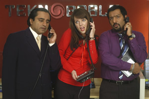 Mumbai Calling. Image shows from L to R: Kenny Gupta (Sanjeev Bhaskar), Terri Johnson (Daisy Beaumont), Dev (Nitin Ganatra). Copyright: Allan McKeown Presents Mumbai Calling. Image shows from L to R: Kenny Gupta (Sanjeev Bhaskar), Terri Johnson (Daisy Beaumont), Dev (Nitin Ganatra). Copyright: Allan McKeown Presents