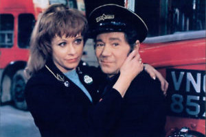 Mutiny On The Buses. Image shows from L to R: Suzy (Janet Mahoney), Stan Butler (Reg Varney). Copyright: STUDIOCANAL
