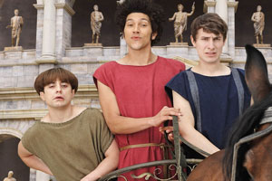 Plebs. Image shows from L to R: Grumio (Ryan Sampson), Stylax (Joel Fry), Marcus (Tom Rosenthal). Copyright: RISE Films