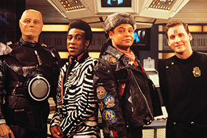 Red Dwarf. Image shows left to right: Kryten (Robert Llewellyn), Cat (Danny John-Jules), Lister (Craig Charles), Rimmer (Chris Barrie)