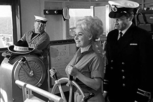 San Ferry Ann. Image shows from L to R: Hiker Girl (Barbara Windsor), Ship's Officer (Paul Grist)