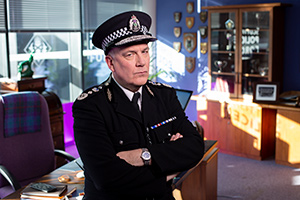 Scot Squad. Chief Commissioner Cameron Miekelson (Jack Docherty). Copyright: The Comedy Unit
