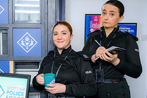 Scot Squad. Image shows left to right: PC Sharon McKelvie (Phoebe Connolly), Sergeant Karen Ann Millar (Karen Bartke). Credit: The Comedy Unit
