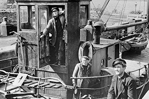 The Maggie. Image shows from L to R: The Skipper (Captain Peter MacTaggart) (Alex Mackenzie), The Engineman (McGregor) (Abe Barker), The Mate (Hamish) (James Copeland). Copyright: STUDIOCANAL / Ealing Studios