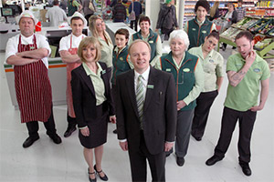 Trollied. Image shows from L to R: Andy (Mark Addy), Kieran (Nick Blood), Julie (Jane Horrocks), Linda (Faye McKeever), Katie (Chanel Cresswell), Gavin (Jason Watkins), Sue (Lorraine Cheshire), Margaret (Rita May), Leighton (Joel Fry), Lisa (Beverly Rudd), Colin (Carl Rice). Copyright: Roughcut Television