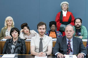 We The Jury. Image shows from L to R: Jen 1 (Sophie Thompson), Olivia (Diane Morgan), Sam (Kae Alexander), William (Edward Easton), Wolf (Vivienne Acheampong), Judge Henman (Maggie Steed), Mr Martin (David Schaal), Hugh (Kenneth Collard). Copyright: Big Talk Productions