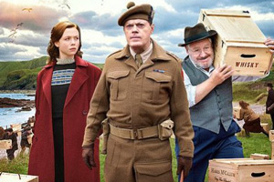 Whisky Galore!. Image shows from L to R: Peggy Macroon (Naomi Battrick), Captain Paul Wagget (Eddie Izzard), Joseph Macroon (Gregor Fisher). Copyright: Whisky Galore Movie Plc