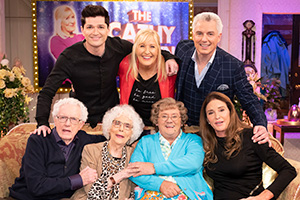 All Round To Mrs. Brown's. Image shows from L to R: John Barrowman, Danny O'Donoghue, Marion Barrowman, Cathy Brown (Jennifer Gibney), Mrs Brown (Brendan O'Carroll), John Barrowman, Caitlyn Jenner