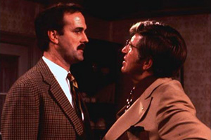 Fawlty Towers. Image shows from L to R: Basil Fawlty (John Cleese), Mr Hamilton (Bruce Boa). Copyright: BBC