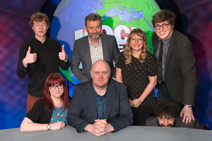 Mock The Week. Image shows from L to R: James Acaster, Angela Barnes, Hugh Dennis, Dara O Briain, Kerry Godliman, Glenn Moore, Nish Kumar. Copyright: Angst Productions