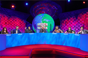 Mock The Week. Image shows from L to R: Angela Barnes, Hugh Dennis, Rhys James, Dara O Briain, Milton Jones, Maisie Adam, Ed Gamble. Copyright: Angst Productions