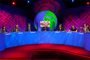 Mock The Week. Image shows from L to R: Angela Barnes, Hugh Dennis, Glenn Moore, Dara O Briain, Evelyn Mok, Maisie Adam, Ed Byrne. Copyright: Angst Productions