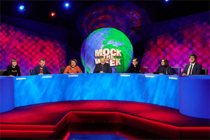 Mock The Week. Image shows from L to R: Maisie Adam, Hugh Dennis, Milton Jones, Dara O Briain, Rhys James, Emily Lloyd Saini, Glenn Moore