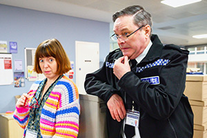 Piglets. Image shows left to right: Melanie (Rebecca Humphries), Superintendent Bob Weekes (Mark Heap)