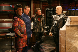 Red Dwarf. Image shows from L to R: Cat (Danny John-Jules), Rimmer (Chris Barrie), Lister (Craig Charles), Kryten (Robert Llewellyn). Copyright: UKTV