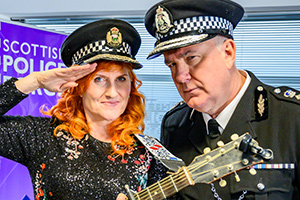 Scot Squad. Image shows from L to R: Eddi Reader, Chief Commissioner Cameron Miekelson (Jack Docherty)