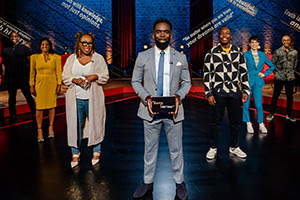 Sorry, I Didn't Know. Image shows left to right: Emmanuel Sonubi, Shazia Mirza, Chizzy Akudolu, Jimmy Akingbola, Eddie Kadi, Suzi Ruffell, Colin Jackson